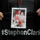 A mourner holds up a photo of police shooting victim Stephon Clark during the funeral services for Clark at Bayside Of South Sacramento Church March 29, 2018 in Sacramento, California.
